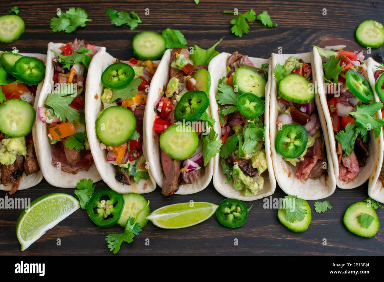 Grilled Flank Steak Tacos with Guacamole and Pico de Gallo Beef tacos in flour tortillas topped