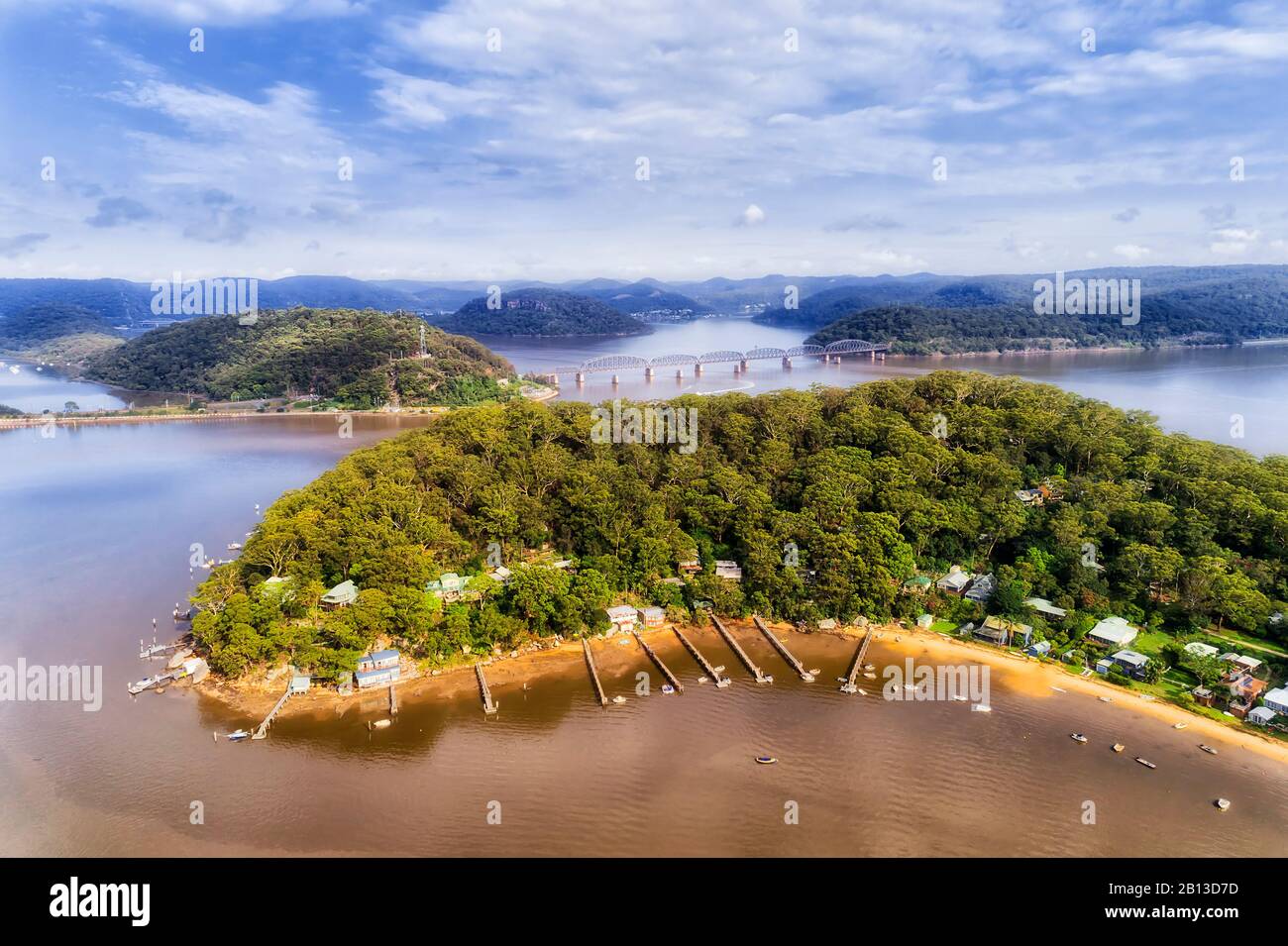 Dangar island on Hawkesbury river in view of railway bridge of Sydney trains connecting greater Sydney to the Central coast. Stock Photo
