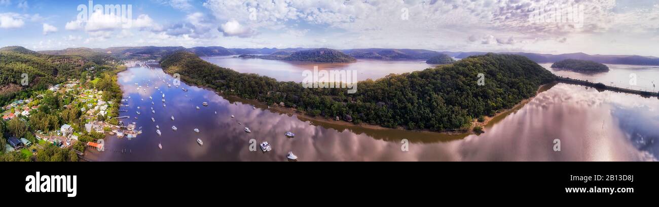 Wide aerial panorama over Hawkesbury river with Brooklyn village agains Long island with local marina and oyster farms. Stock Photo