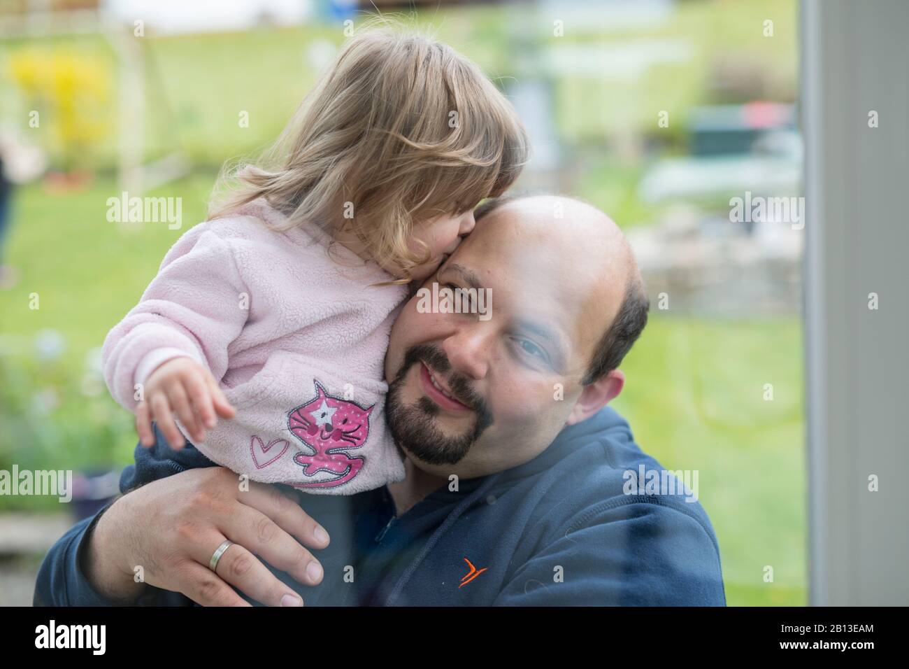 Little girl kissing her father Stock Photo