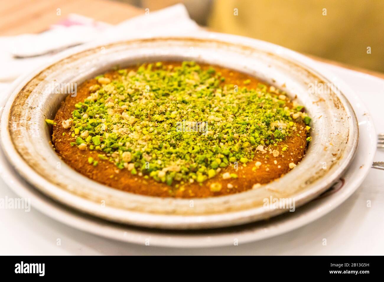 famous turkish desserts (kunefe) with cheese, walnut and pistachios