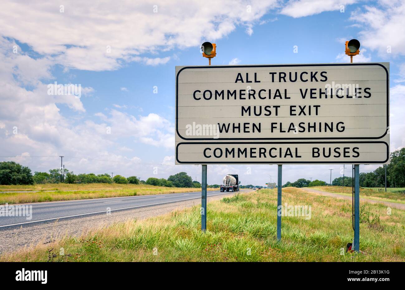 Semi truck weight station sign in Texas with traffic lights and trucks passing by / Commercial vehicles inspection station indicator Stock Photo