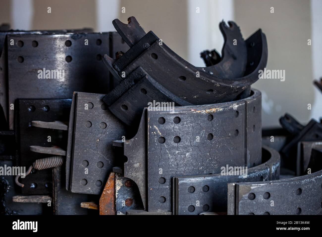 Pile of used truck brake shoes, stored to be recycled and reused, re-manufacturing and waste reduction of automotive parts business concept Stock Photo