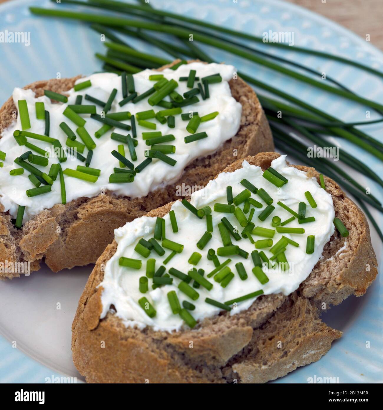 chives, sand leek (Allium schoenoprasum), slices of bread with curd and chives Stock Photo