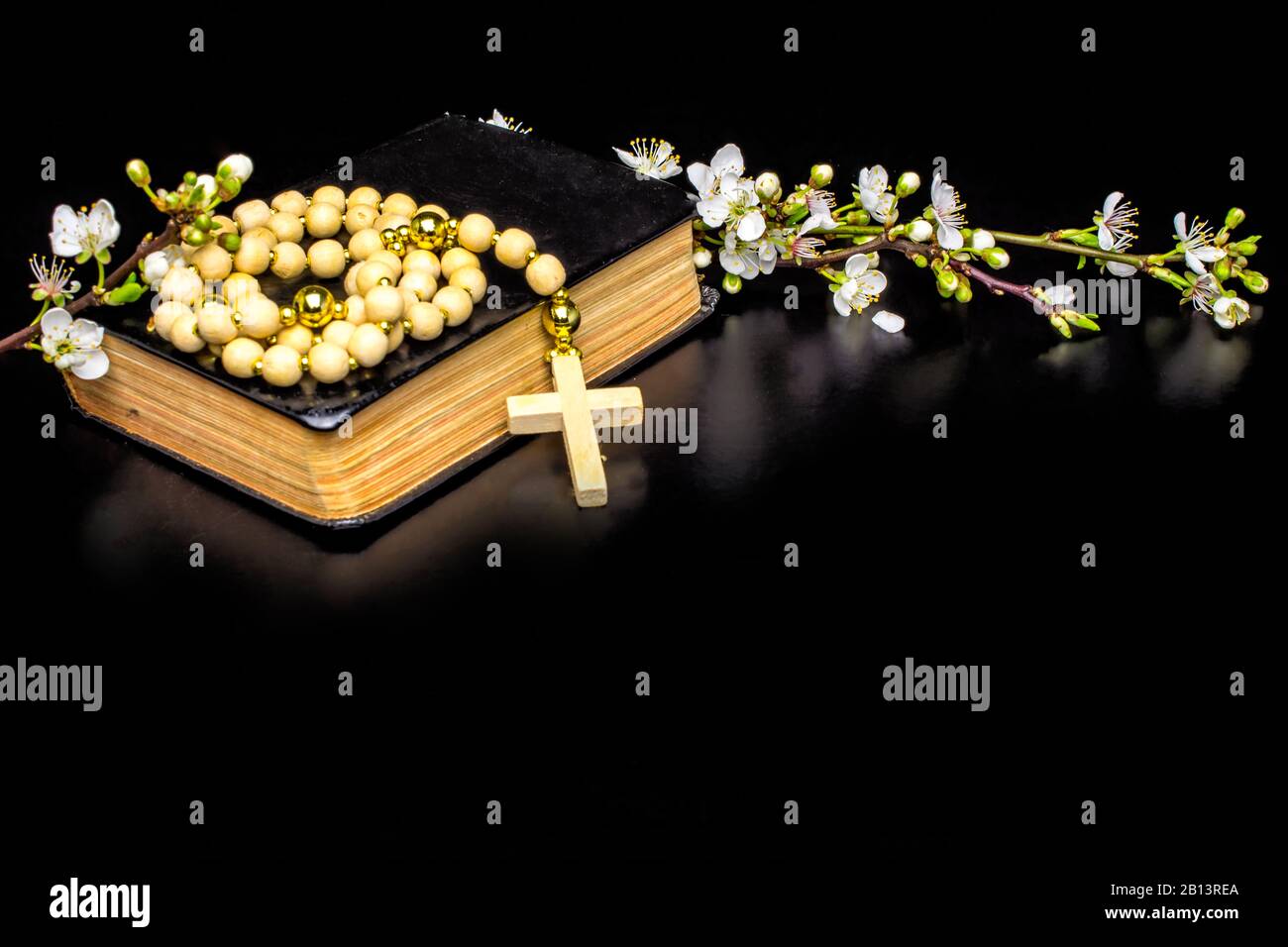 wooden rosary plum tree white flowers bible Stock Photo