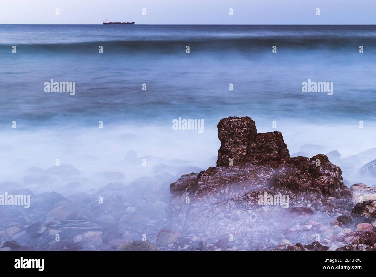 Long exposure photo of the sea, where the waves breaks over the stones in Mazatlan Stock Photo