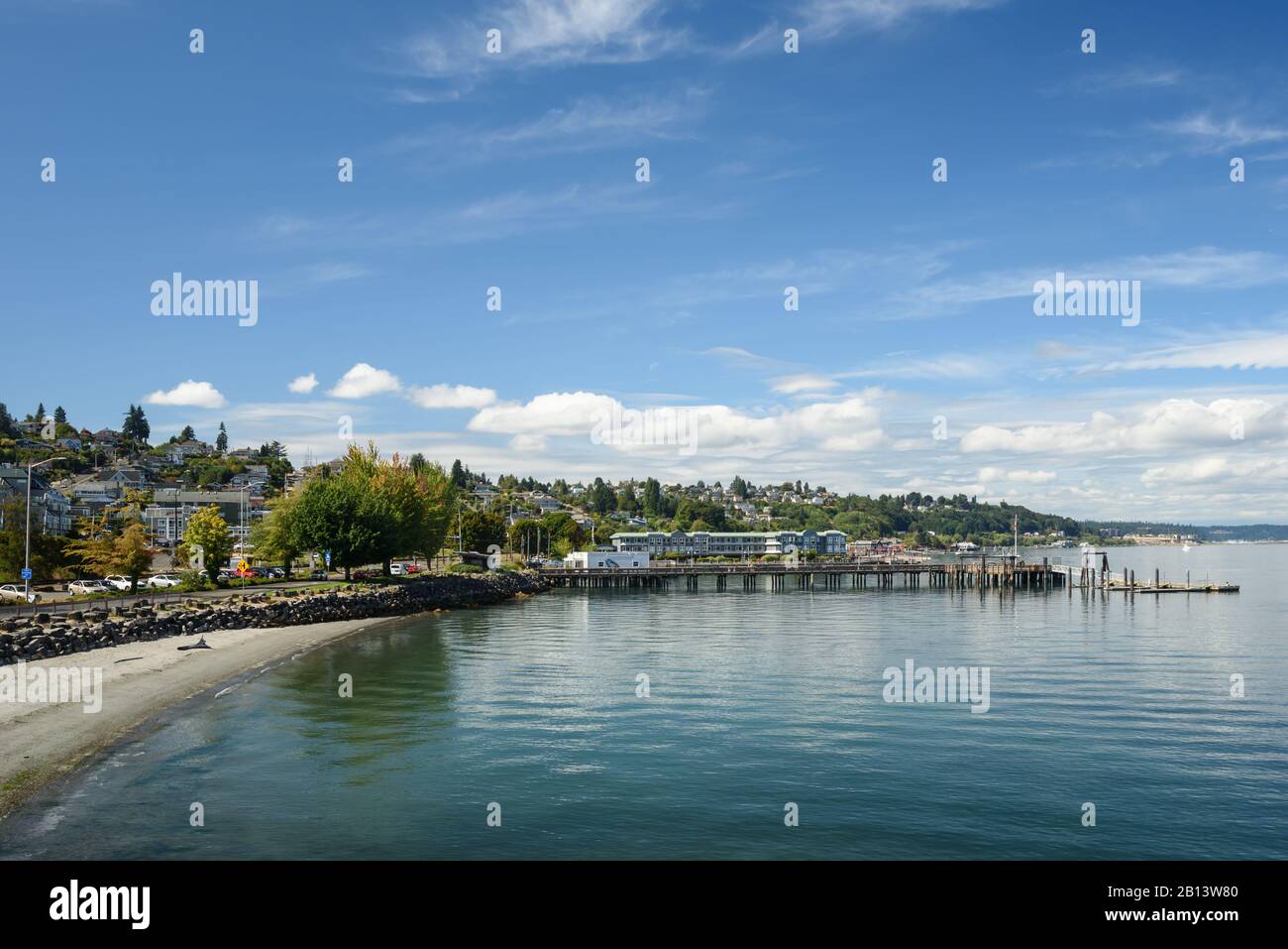 Small quiet beach tucked along Ruston Way in Tacoma on a calm summer afternoon. Stock Photo