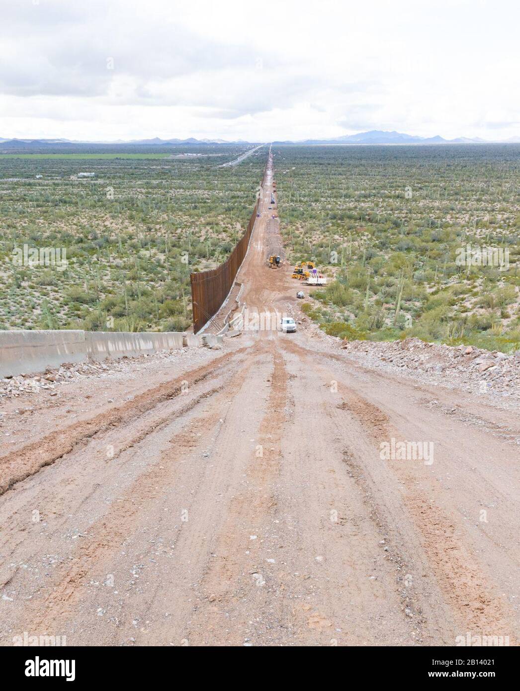 Looking west, midway atop Monument Mountain. Barrier recedes into the horizon. The Tucson 2 project spans five miles, near Douglas AZ, February 11, 2020. The U.S. Army Corps of Engineers, South Pacific Border District is providing contracting services, including design and construction oversight, of Department of Defense-funded Southwest border barrier projects in California, Arizona, New Mexico and Texas at the direction of the Administration and at the request of Department of Homeland Security, Customs and Border Protection. (no one in this image crossed the international border) Stock Photo