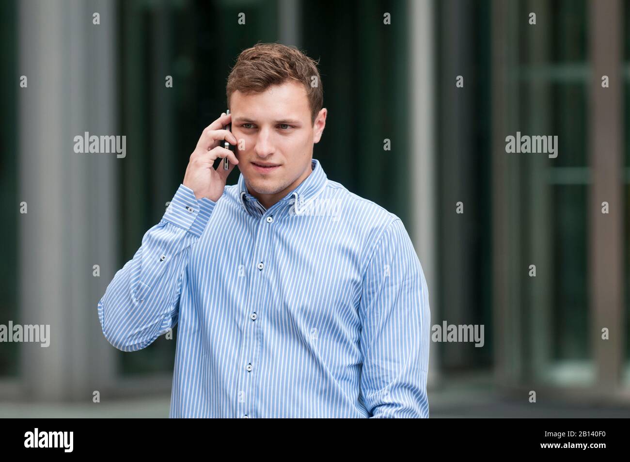 Young man is talking on mobile phone Stock Photo