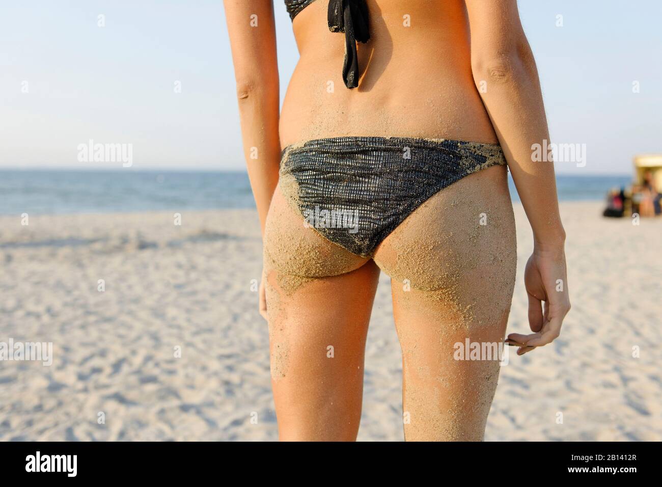 Young woman, 20+, standing on the beach, buttocks, sand, bikini, summer,  lifestyle, Niendorf on the Baltic Sea, Schleswig-Holstein, Germany, Europe  Stock Photo - Alamy