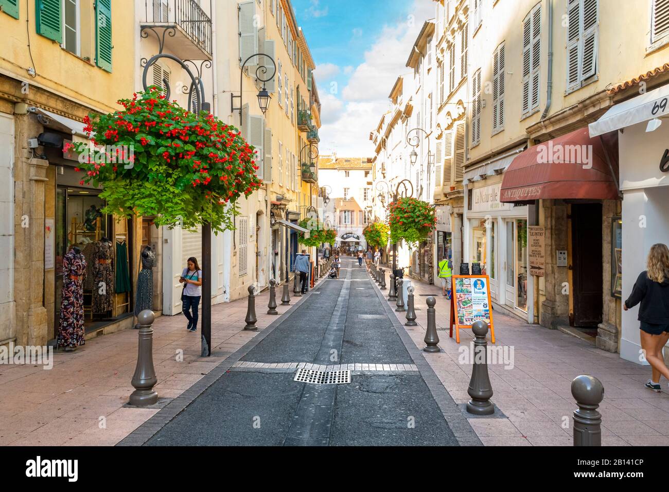 A typical, picturesque street of shops and apartments in Antibes, France, on the south coast and along the Mediterranean Sea. Stock Photo