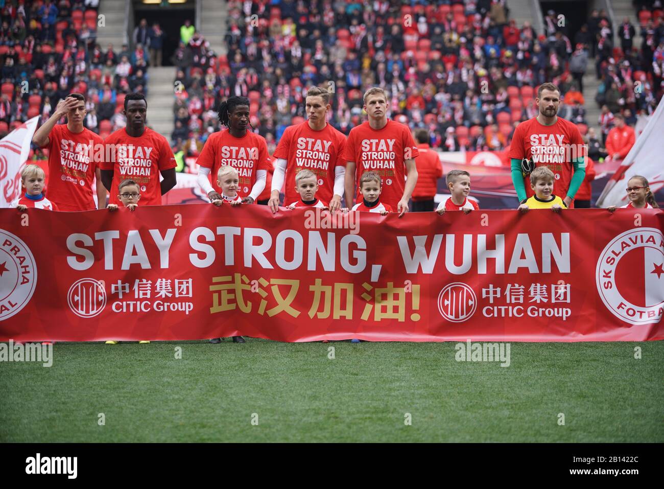 Prague, Czech Republic. 22nd Feb, 2020. The line-up players of SK Slavia Praha wearing jerseys with the message 'Stay strong Wuhan' in English and Mandarin pose prior to their Czech Liga match against SFC Opava in Prague, the Czech Republic, Feb. 22, 2020. Czech top-flight team SK Slavia Praha expressed solidarity with China in fighting against the novel coronavirus during their 2-0 home win over SFC Opava on Saturday. Credit: Martin Mach/Xinhua/Alamy Live News Stock Photo