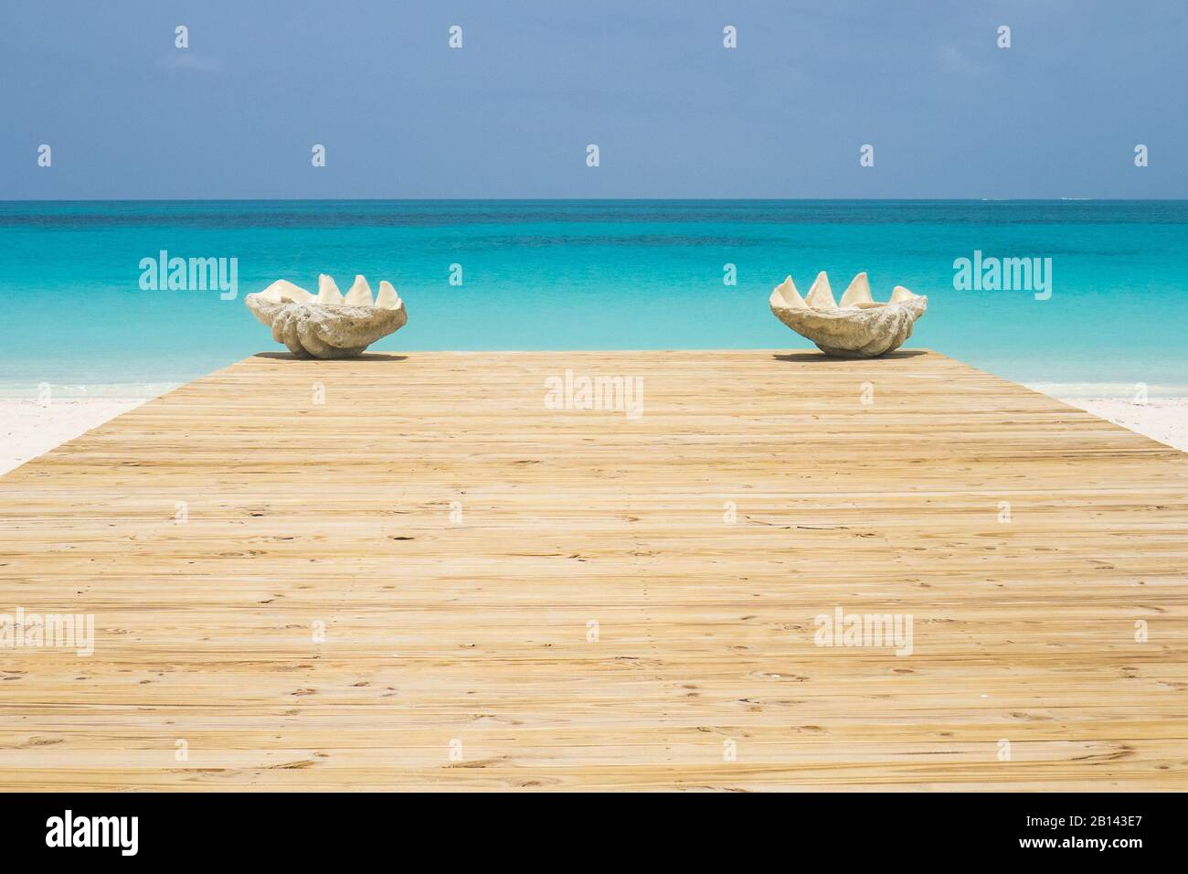 Bahamas Beach Scene with Turquoise Caribbean Ocean - Two Seashells on a Wooden Terrace on Bimini Stock Photo