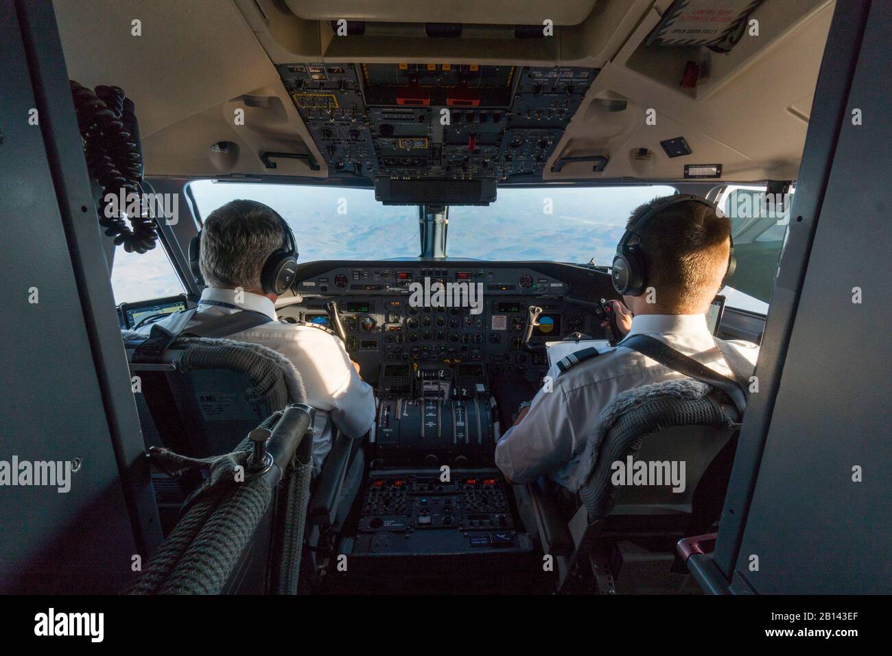 Two pilots in the cockpit of an airplane over Disko Bay, Greenland Stock Photo