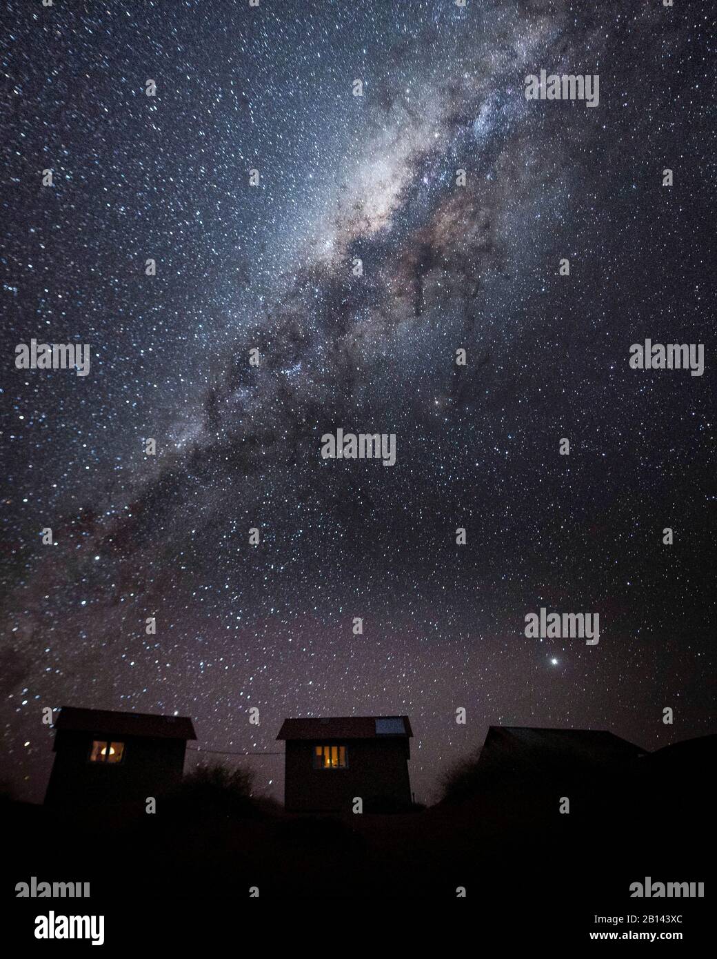 Small huts in front of Milky Way, Namibia Stock Photo