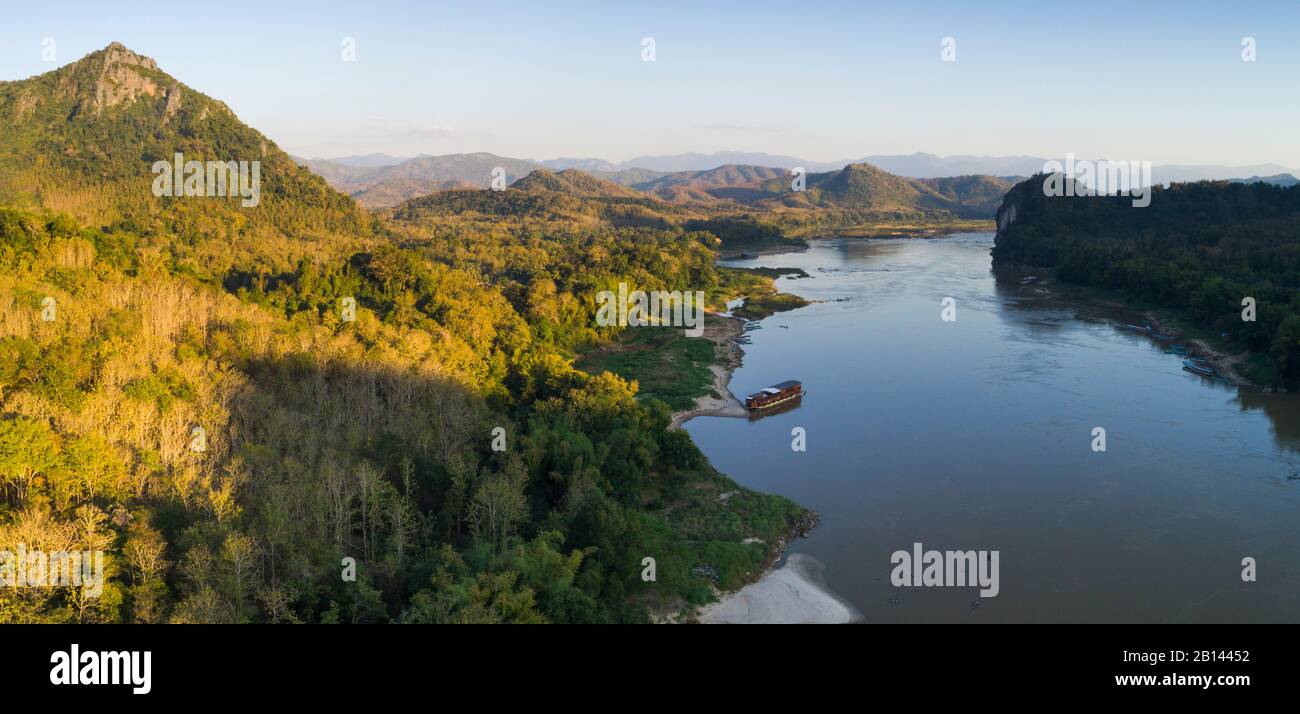 River cruise ship Mekong Sun lies at night on a shore, Laos Stock Photo