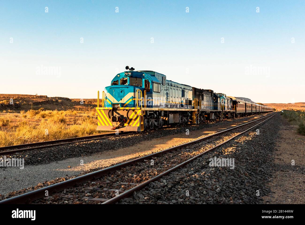 Train on tracks at sunrise in South Africa Stock Photo