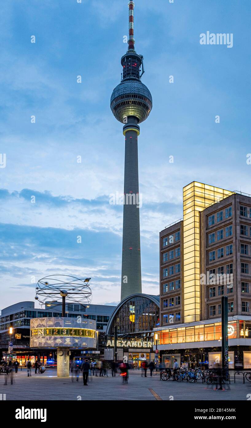 World time clock, train station and Berolina House on Alexanderplatz, in the back television tower, Mitte, Berlin Stock Photo