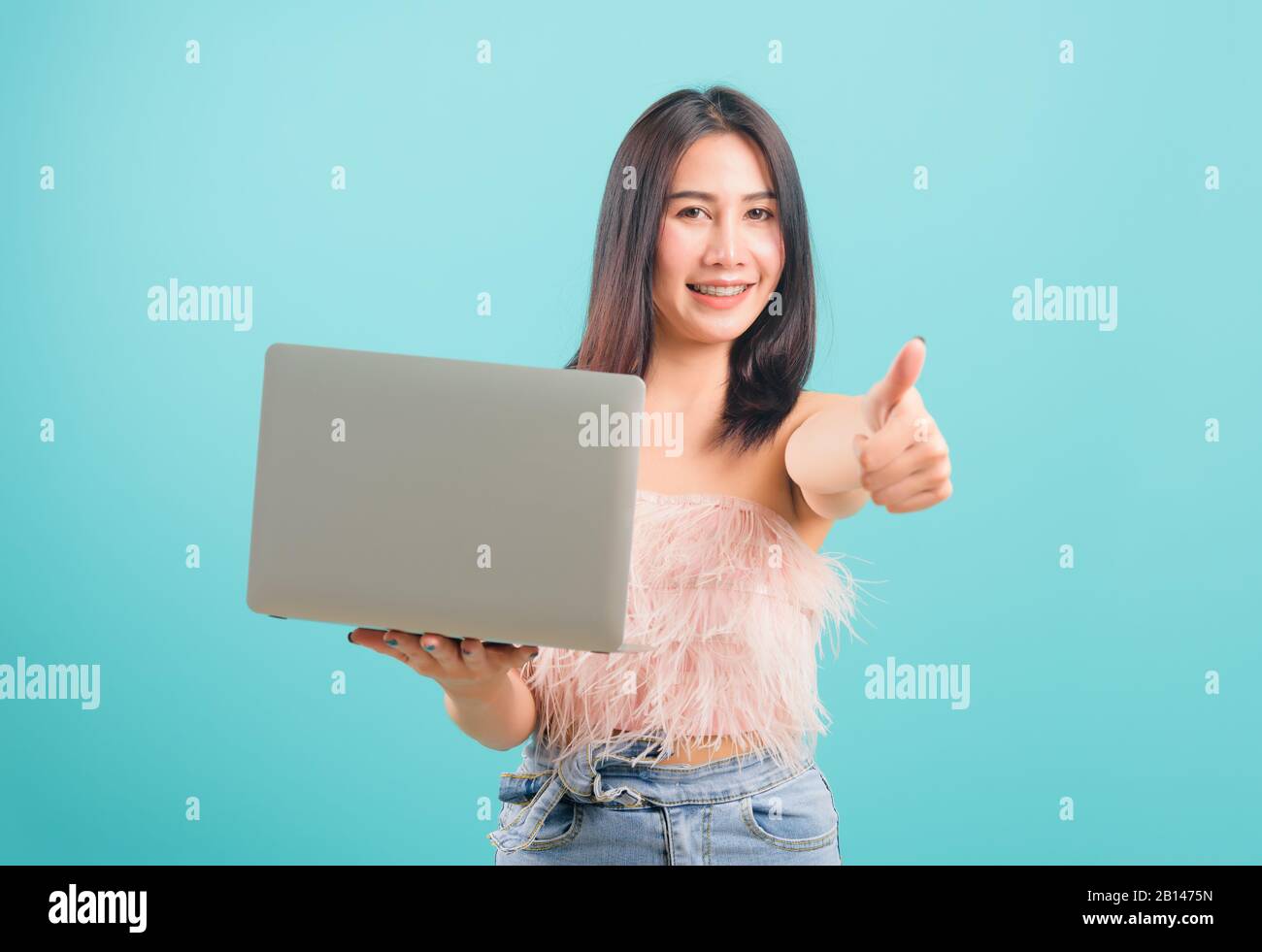 Smiling face portrait asian beautiful woman holding laptop computer and ...