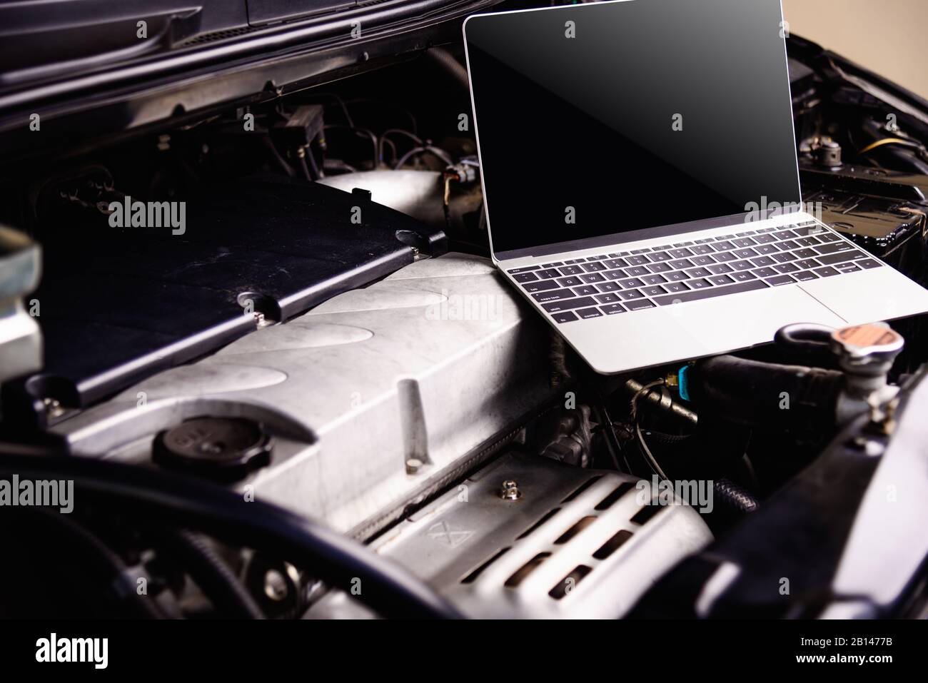 Laptop computer on car mechanic engine for service at workshop Stock ...