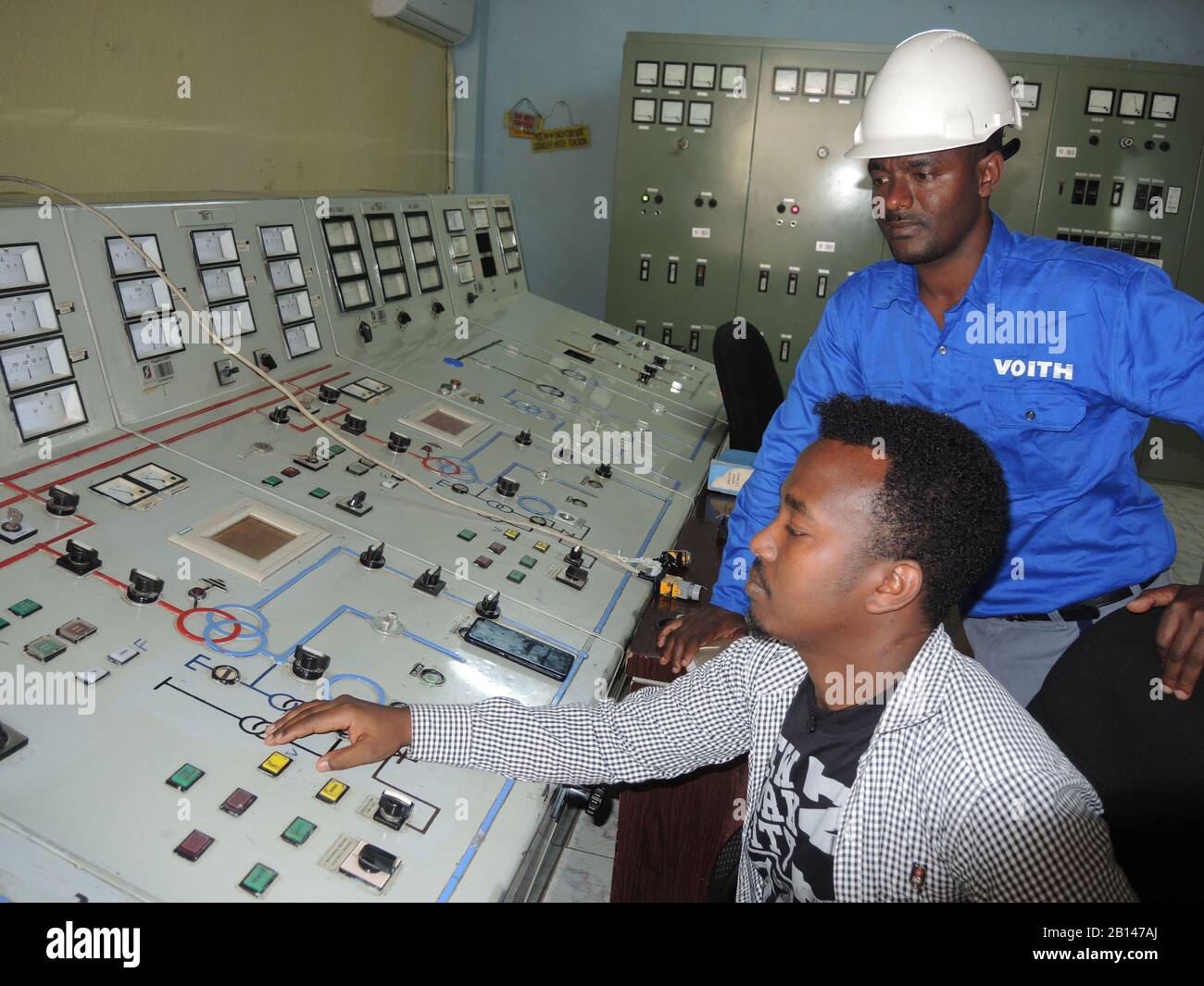 Koka Wasserkraftwerk, Ethiopia. 21st Jan, 2020. Electrical engineer Sisey Hussein (front) and Voith expert Mulugeta Mitiku work at the control panel of the coca water power station in Ethiopia. (to dpa: 'Powerhouse instead of hunger country - southwest shows the flag in Ethiopia') Credit: Thomas Burmeister/dpa/Alamy Live News Stock Photo