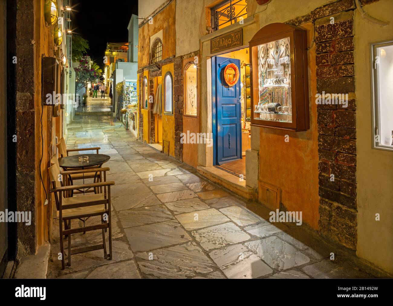 SANTORINI, GREECE - OCTOBER 4, 2015: The street of Oia with the souvenirs shops and restaurants at night. Stock Photo