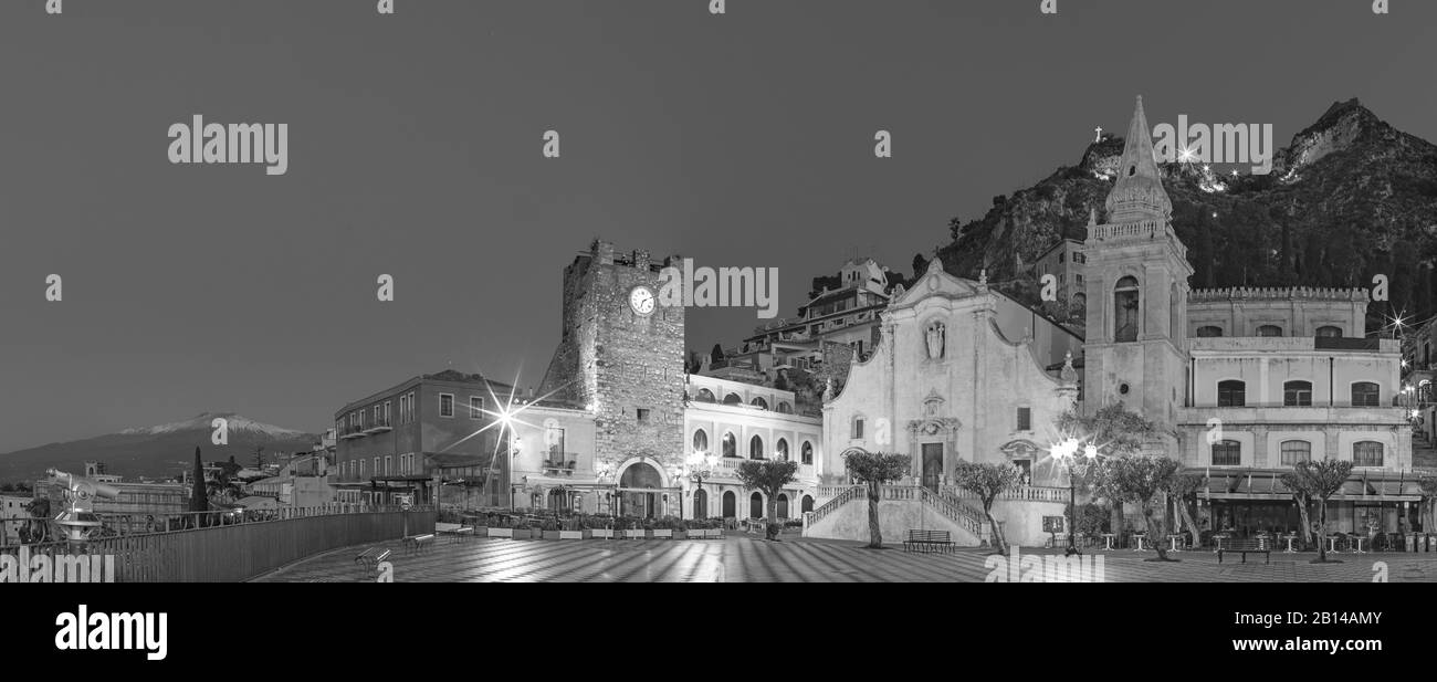 Taormina - The square Piazza IX Aprile and St. Joseph church, Porta di Mezzo gate and Mt. Etna volcano in the background. Stock Photo