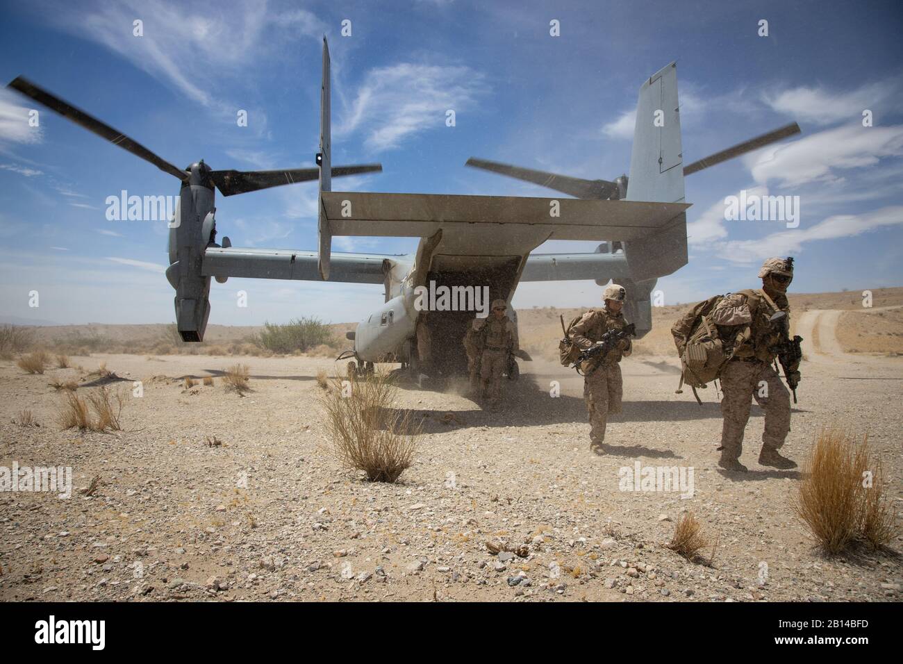 U.S. Marines assigned to 2nd Battalion, 7th Marine Regiment dismount an MV-22B Osprey assigned to Marine Medium Tiltrotor Squadron 263 while conducting a tactical insert during Integrated Training Exercise (ITX) 5-19 at Marine Corps Air Ground Combat Center, Twenty-nine Palms, California, Aug. 3, 2019. ITX 5-19 is a large scale, combined-arms training exercise that produces combat-ready forces capable of operating as an integrated Marine Air-Ground Task Force. (U.S. Marine Corps photo by Cpl. Cody Rowe) Stock Photo