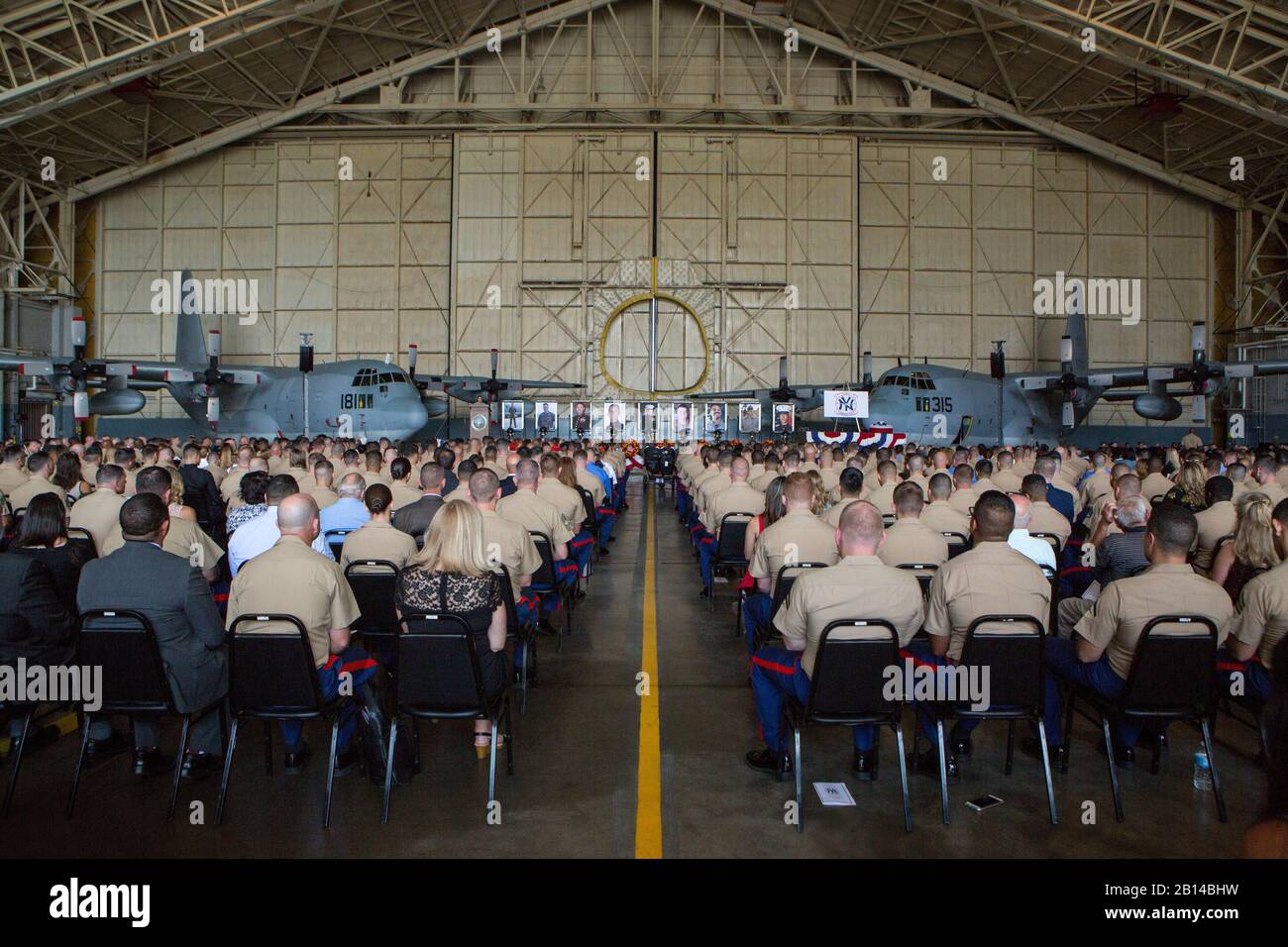 An audience waits for the invocation of a memorial ceremony to honor nine U.S. Marines assigned to Marine Aerial Refueler Transport Squadron 452, Marine Aircraft Group 49, 4th Marine Aircraft Wing, Marine Forces Reserve, at Stewart Air National Guard Base in Newburgh, New York, Aug. 27, 2017. The memorial was held to honor the lives of nine VMGR-452 Marines who perished in a KC-130T accident that killed 15 Marines and one Sailor, July 10, 2017. (U.S. Marine Corps photo by Cpl. Dallas Johnson) Stock Photo