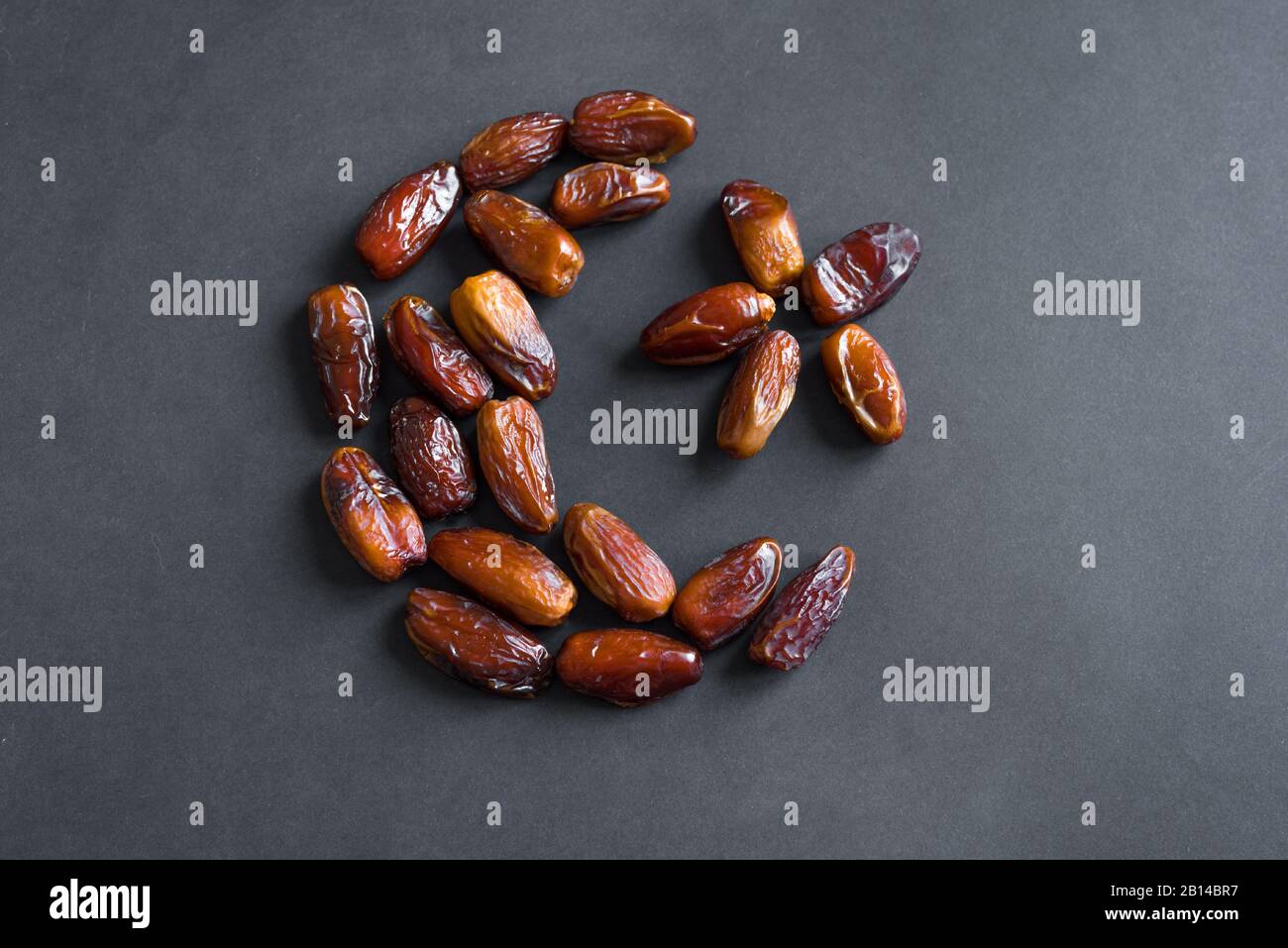 Ramadan kareem with dates fruits arranged in shape of crescent moon on ...