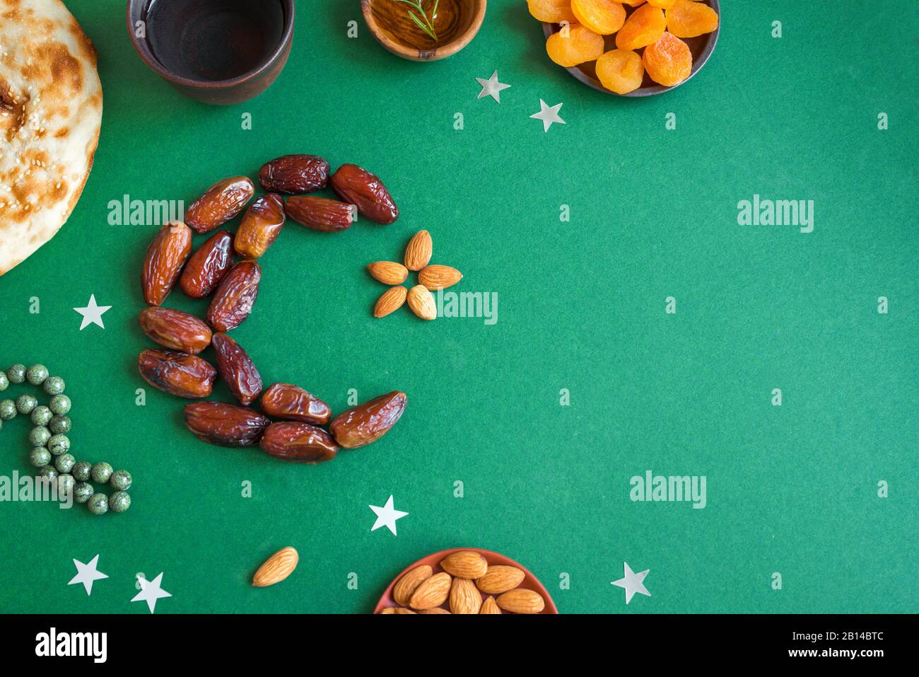 Ramadan kareem with dates fruits arranged in shape of crescent moon ...
