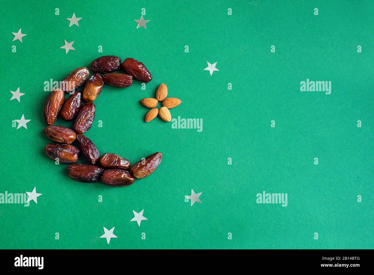 Ramadan kareem with dates fruits arranged in shape of crescent moon ...