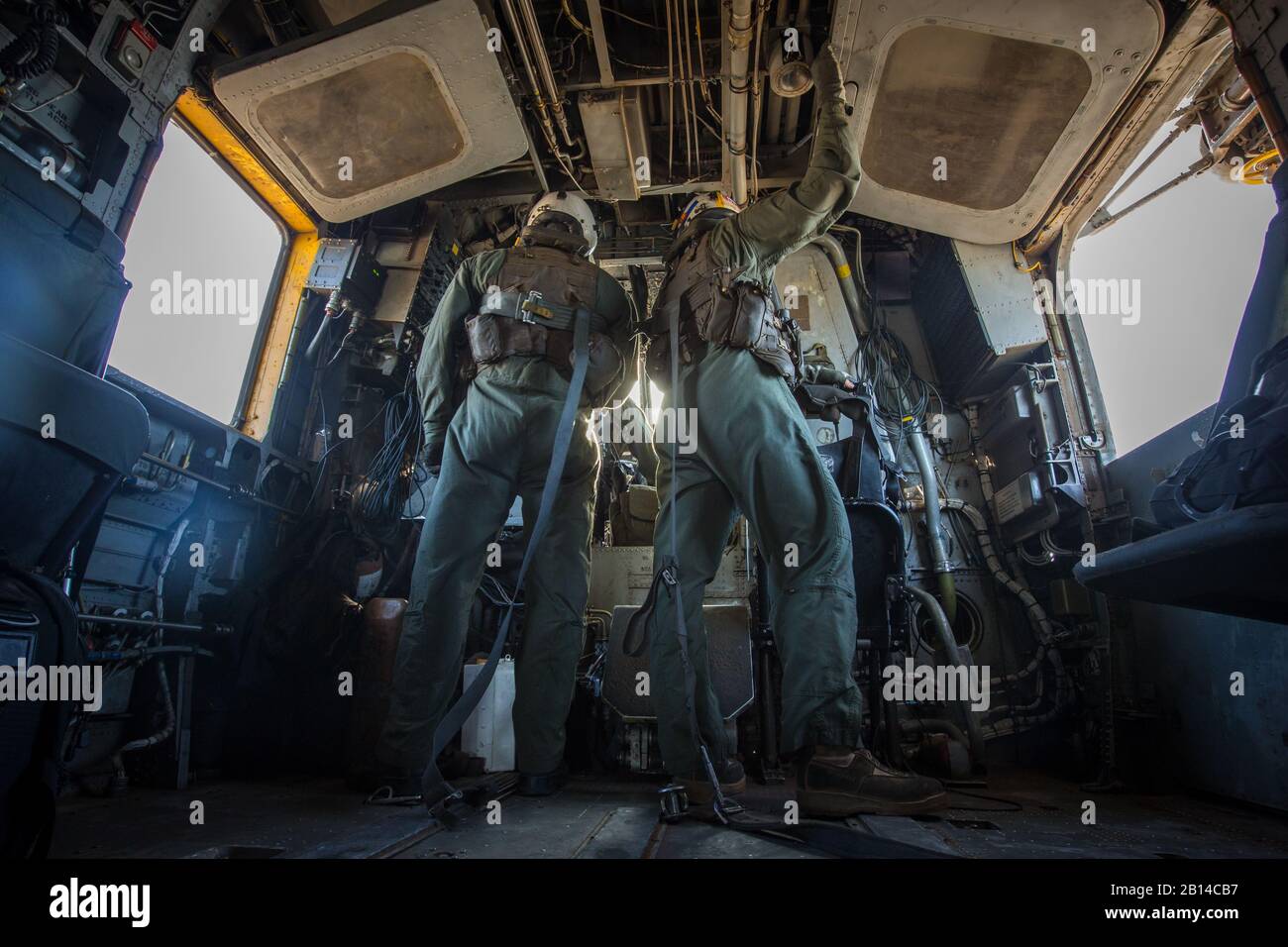 U.S. Marine Corps Lance Cpl. Mason DiNicola, left, and Cpl. Bradley Lauer, crew chiefs with Marine Heavy Helicopter Squadron (HMH) 466, look into a CH-53E Super Stallion cockpit during a tactical support insert and extract exercise in part of Weapons and Tactics Instructors course (WTI) 2-17 at Naval Air Facility El Centro, Calif., April 15, 2017. WTI is held biannually at Marine Corps Air Station (MCAS) Yuma, Ariz. to provide students with detailed training to be practiced on the various ranges in Arizona and California. (U.S. Marine Corps photo by Cpl. Trever A. Statz) Stock Photo
