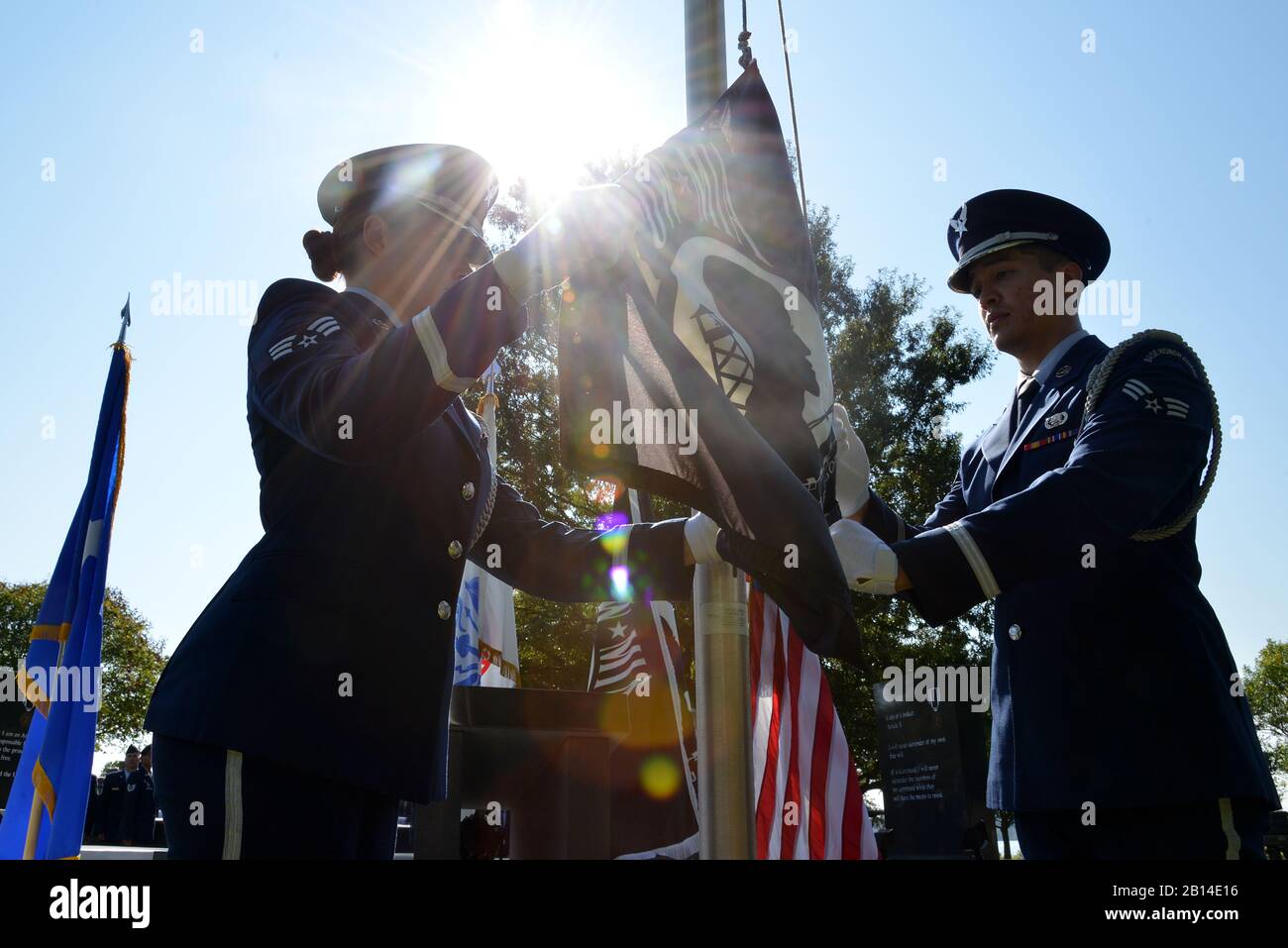 U.S. Airmen assigned to the Langley Air Force Base Honor Guard raise the POW/MIA flag during the POW/MIA Remembrance Day ceremony at Joint Base Langley-Eustis, Va., Sept. 15, 2017. A moment of silence was taken as the community honored and remembered those still missing in action and prisoners of war. (U.S. Air Force photo by Airman 1st Class Alexandra Singer) Stock Photo