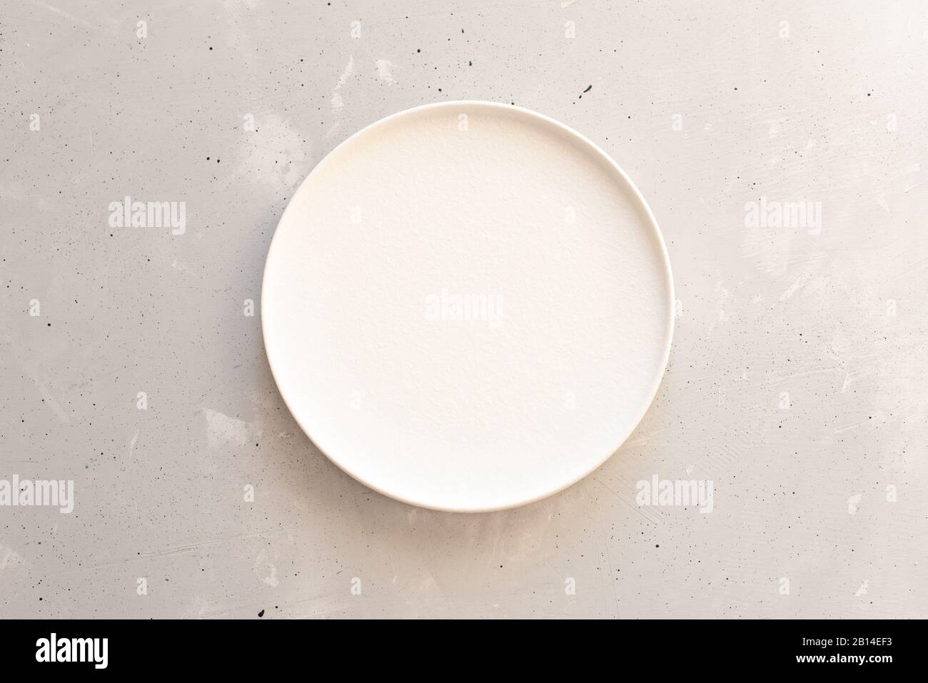 Empty plate on grey wooden table. Stock Photo