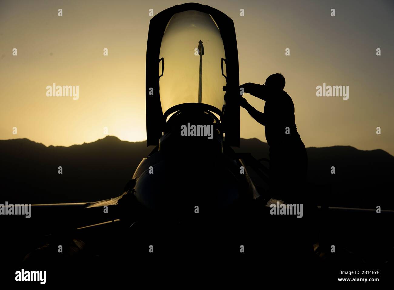 Senior Airman Alexis Garrido, a 455th Expeditionary Aircraft Maintenance Squadron dedicated crew chief, removes paint from an F-16 Fighting Falcon on Bagram Airfield, Afghanistan, June 16, 2017. Maintainers work day and night during extreme heat and freezing weather ensuring “Ops never stops.” (U.S. Air Force photo by Staff Sgt. Benjamin Gonsier) Stock Photo