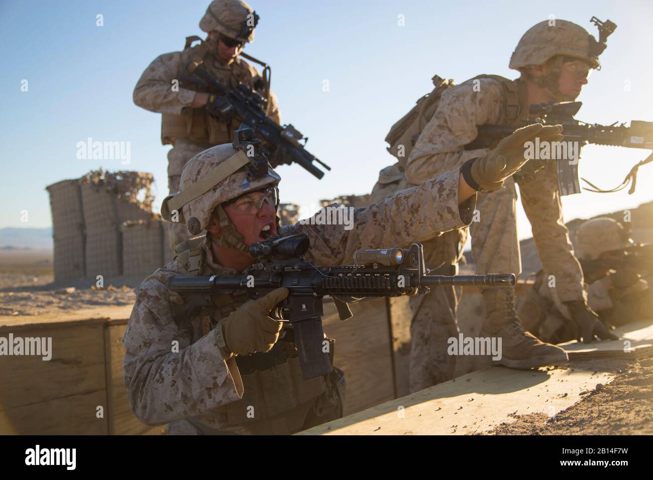 U.S. Marine Corps 1st Lt. Alex Gundy, bottom, the 3rd Platoon commander, Kilo Company, Battalion Landing Team, 3rd Battalion, 1st Marines, gives the order to take the last objective to his Marines during a simulated raid during 13th Marine Expeditionary Unit’s Realistic Urban Training at Twenty-Nine Palms, California, March 1, 2018. RUT is a multi-week training exercise designed to prepare deploying units for real world combat and scenarios. (U.S. Marine Corps photo by Lance Cpl. A. J. Van Fredenberg) Stock Photo