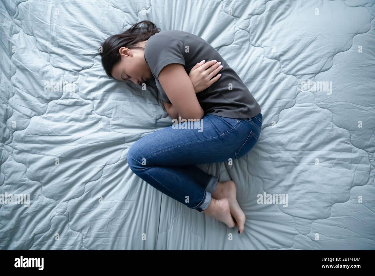 Unhealthy young woman lying in bed feeling depressed Stock Photo Alamy