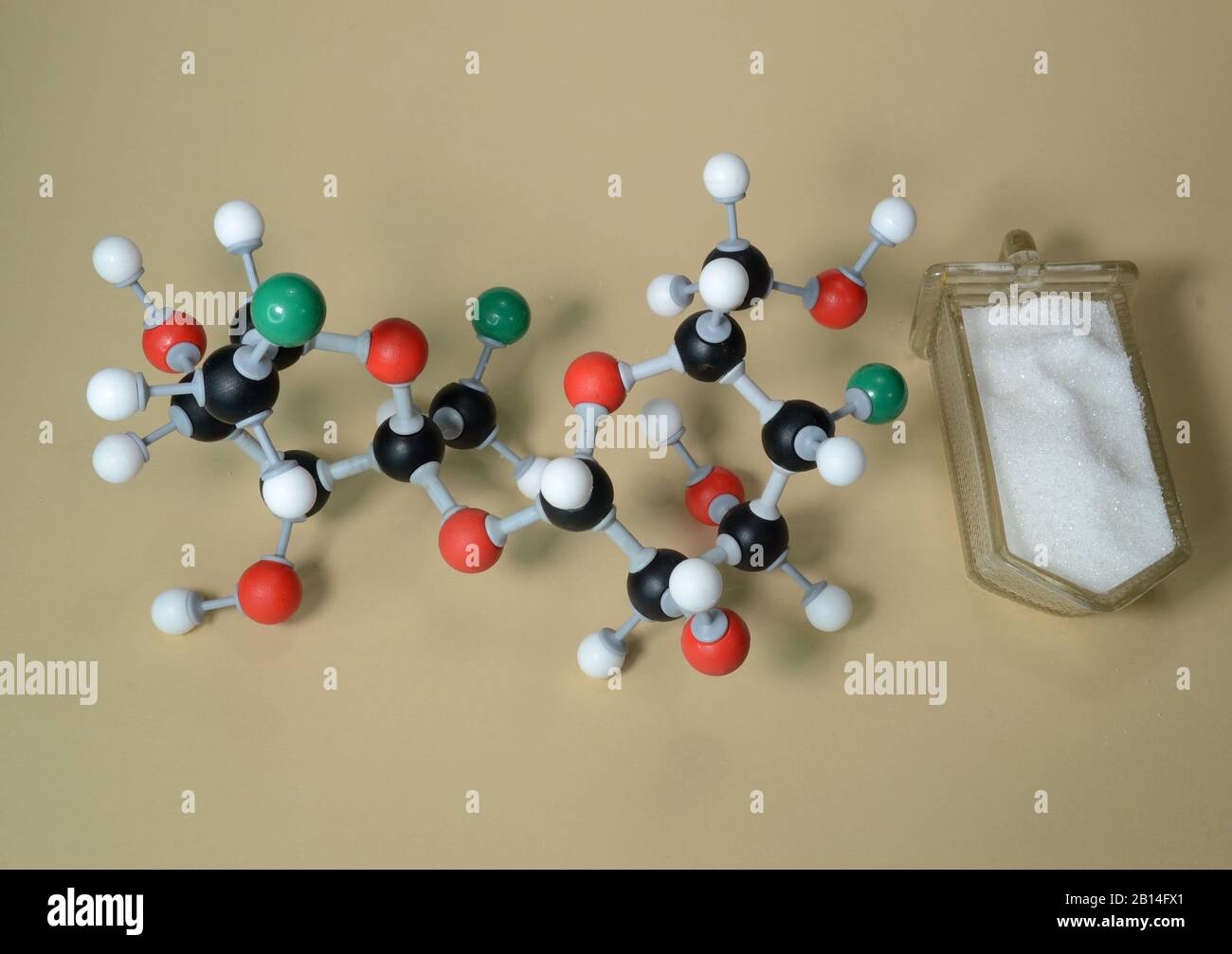 Molecule model of the sweetener Sucralose (E955). White is Hydrogen, black is Carbon, red is Oxygen, and green is chlorine. Stock Photo