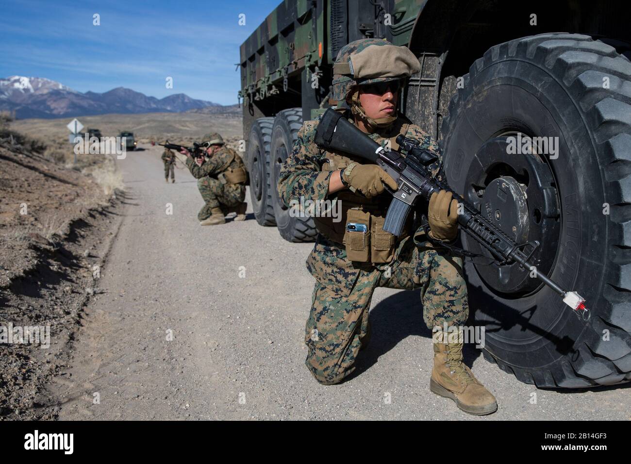 U.S. Marine Corps Lance Cpl. Caleb Estrada, right, a landing support specialist with 2nd Transportation Support Battalion, Combat Logistics Regiment 25, 2nd Marine Logistics Group, provides security for a convoy during improvised explosive device training at Luck Boy Pass Training Area, Marine Corps Mountain Warfare Training Center, Bridgeport, Calif., Feb. 9, 2018. Marines with CLR-25 took part in mountainous tactical convoy training designed to provide the Marines experience in IED recognition, navigation in mountainous terrain, enemy contact drills, and casualty treatment and evacuation. (U Stock Photo