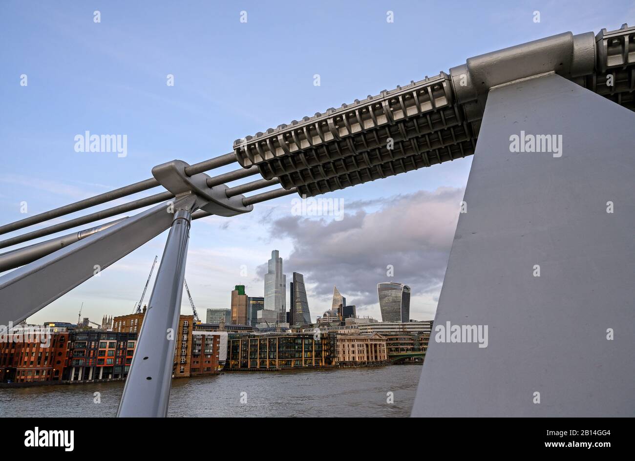 City of London, UK with view over the River Thames framed by the Millennium Bridge. Cityscape of the business district with clouds. London 2020. Stock Photo