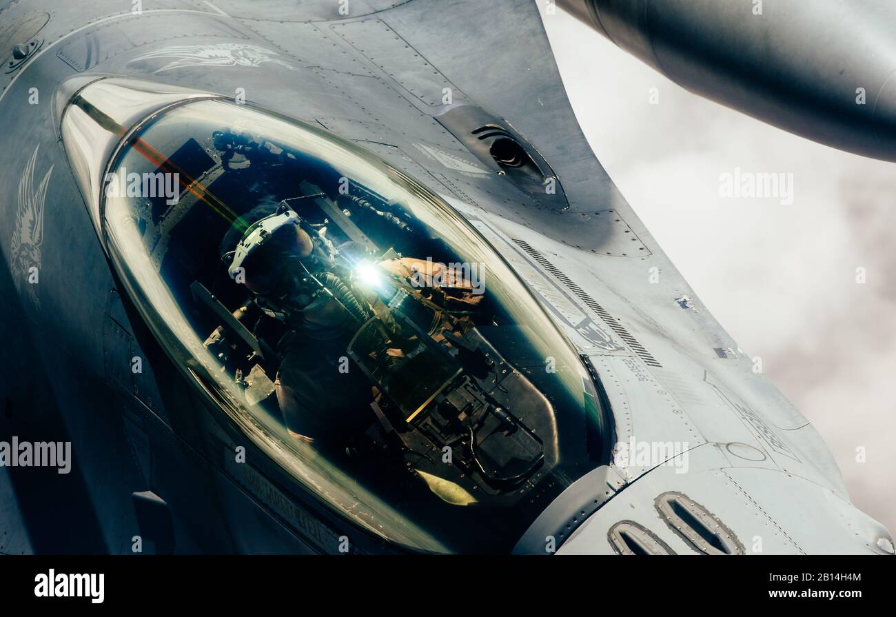 A U.S. Air Force F-16 Fighting Falcon approaches a 908th Expeditionary Aerial Refueling Squadron KC-10 Extender for fuel during a mission in support of Operation Inherent Resolve over the Middle East, March 14, 2019. The 908th EARS empowers the fight against ISIS by providing mission extending aerial refueling services to U.S. and Coalition forces conducting operations in OIR's area of responsibility. (U.S. Air Force photo by Staff Sgt. Jordan Castelan) Stock Photo