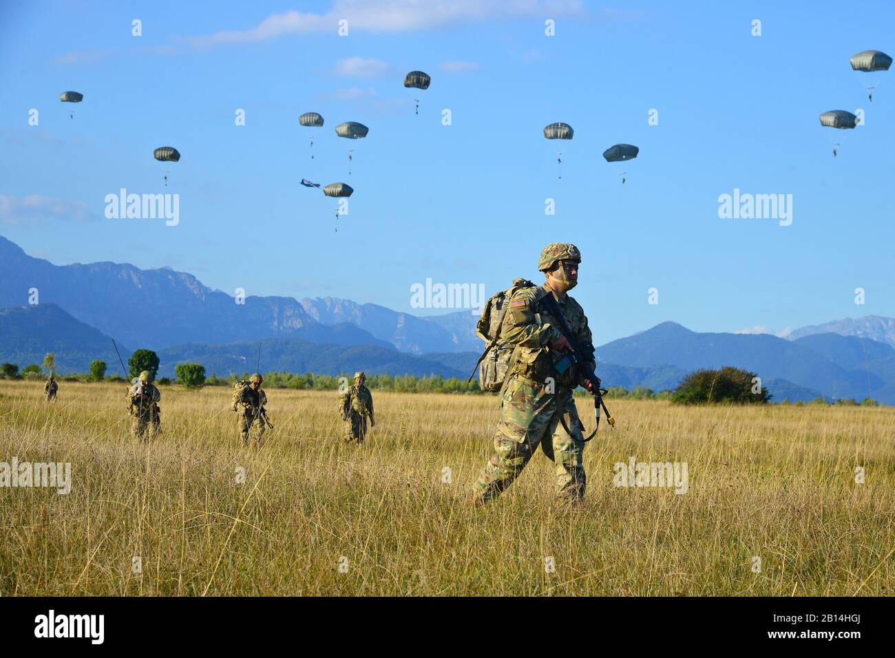 U.S. Army Paratroopers assigned to the Brigade Support Battalion, 173rd Airborne Brigade, move toward an objective after an airborne operation from an Air Force C-130 Hercules aircraft assigned to the 86th Air Wing at Juliet Drop Zone in Pordenone, Italy Sept. 21, 2017. The 173rd Airborne Brigade is the U.S. Army Contingency Response Force in Europe, capable of projecting ready forces anywhere in the U.S. European, Africa or Central Commands' areas of responsibility. (U.S. Army photos by Paolo Bovo) Stock Photo