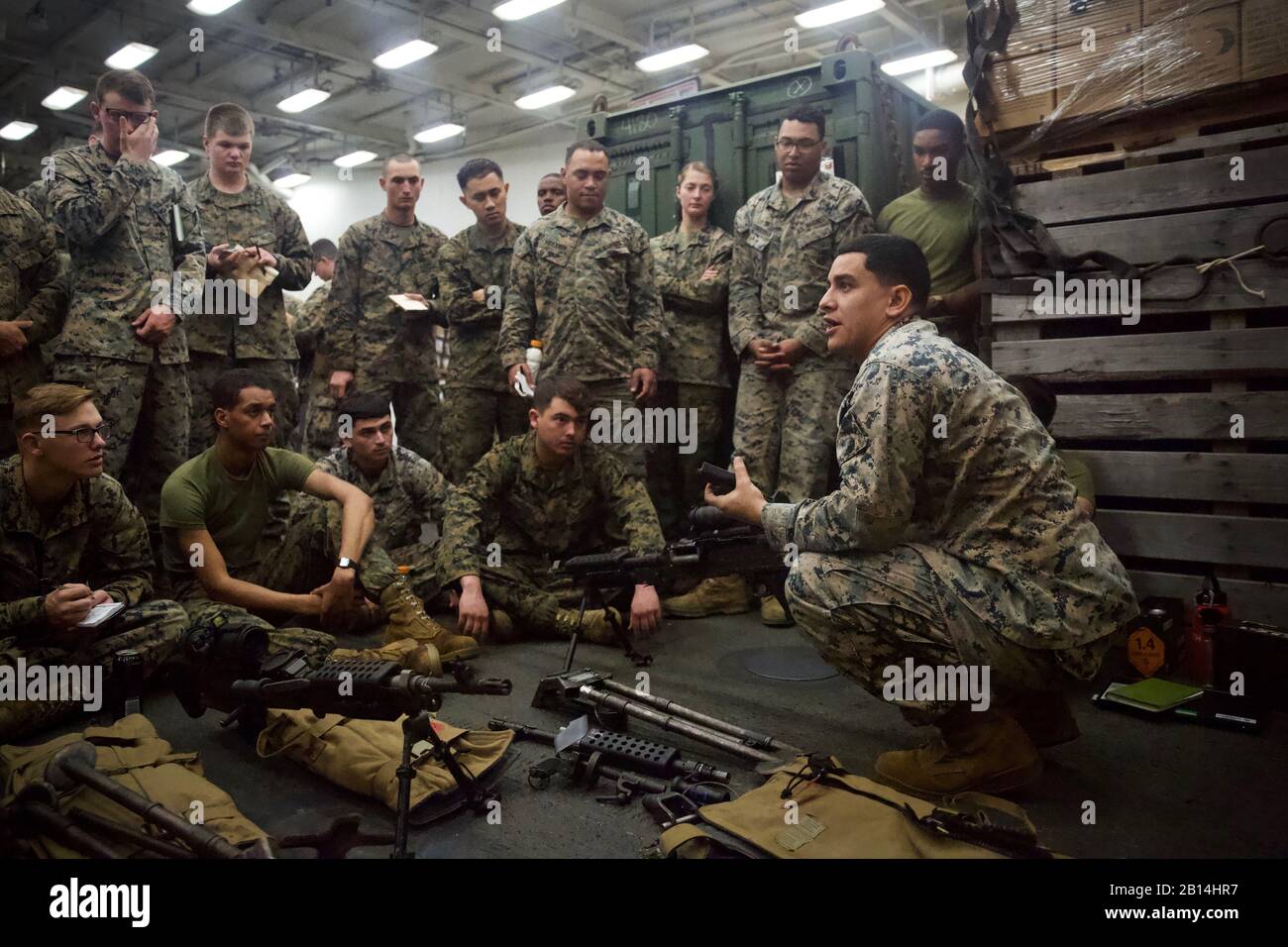 U.S. Marine Corps Sgt. David Steele, right, a small arms technician with Combat Logistics Battalion 31, teaches the specifications of the M240G/B medium machine gun and the M2 .50-caliber Browning machine gun to Marines of CLB-31 aboard the dock landing ship USS Ashland (LSD 48) in the East China Sea, Feb. 6, 2019. Steele, a native of Dallas, graduated from J.J. Pearce High School in May 2010 before enlisting in February 2013. In the near future, CLB-31 plans to incorporate machine gun proficient Marines into fire teams composing vehicle convoys, with medium and heavy machine guns mounted on 7 Stock Photo