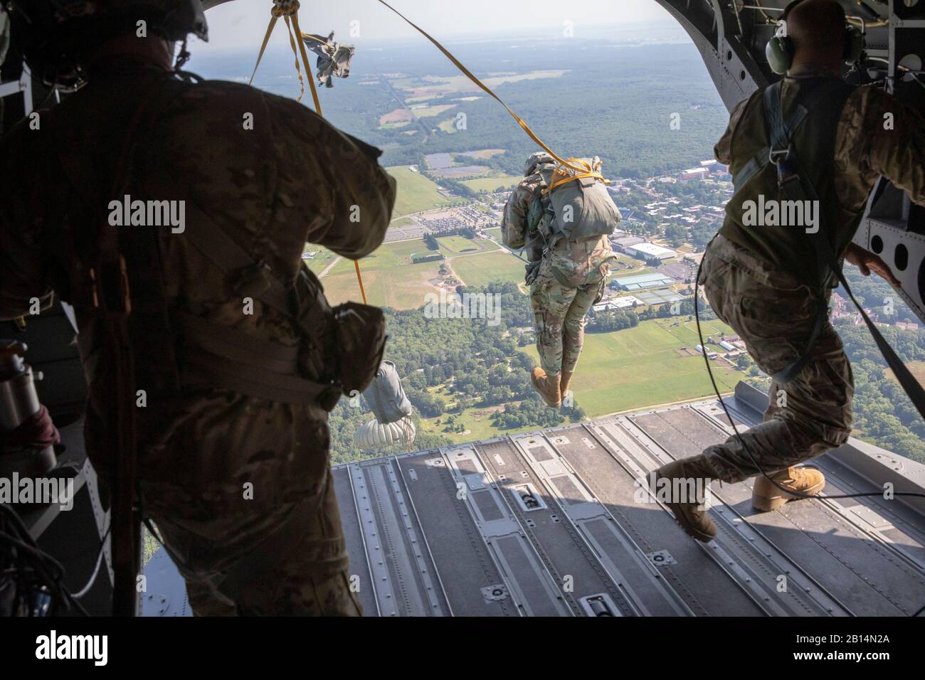 U.S. Army paratroopers, competing in an International Parachute Competition, jumping out of a CH-47 Chinook Helicopter onto Castle Drop Zone during Leapfest 2019 at West Kingston, Rhode Island, August 5, 2019. Leapfest is the largest, longest standing, international static line parachute training event and competition hosted by the 56th Troop Command, Rhode Island Army National Guard to promote high level technical training and esprit de corps within the International Airborne community. (U.S. Army photo by Sgt. Sgt. Rafael DiCristina) Stock Photo