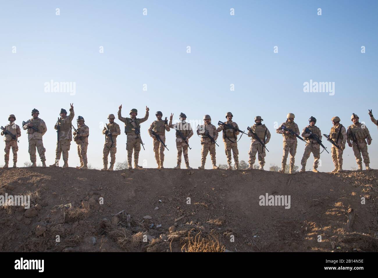 Iraqi security forces soldiers pause for a photo during react to enemy contact training at Camp Taji, Iraq, Feb. 25, 2017. The soldiers attended a Junior Leaders Course led by Coalition forces designed to enhance basic combat skills in support of Combined Joint Task Force – Operation Inherent Resolve, the global Coalition to defeat ISIS in Iraq and Syria.  (U.S. Army photo by Spc. Christopher Brecht) Stock Photo