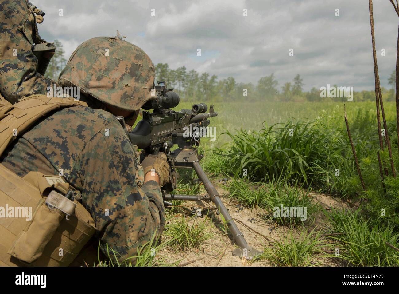A U.S. Marine fires an M240B machine gun at a target during a company attack exercise at Fort A.P. Hill, Va., May 1, 2017. The Marines conducted a live-fire exercise that helped improve their leadership and teamwork abilities. The Marines are with G Company, 2nd Battalion, 2nd Marine Regiment. (U.S. Marine Corps photo by Pfc. Abrey D. Liggins) Stock Photo
