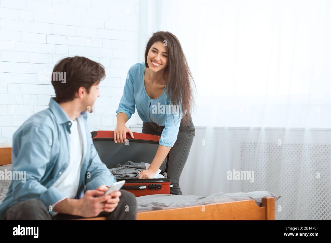 Woman packing suitcase phone hi-res stock photography and images - Alamy