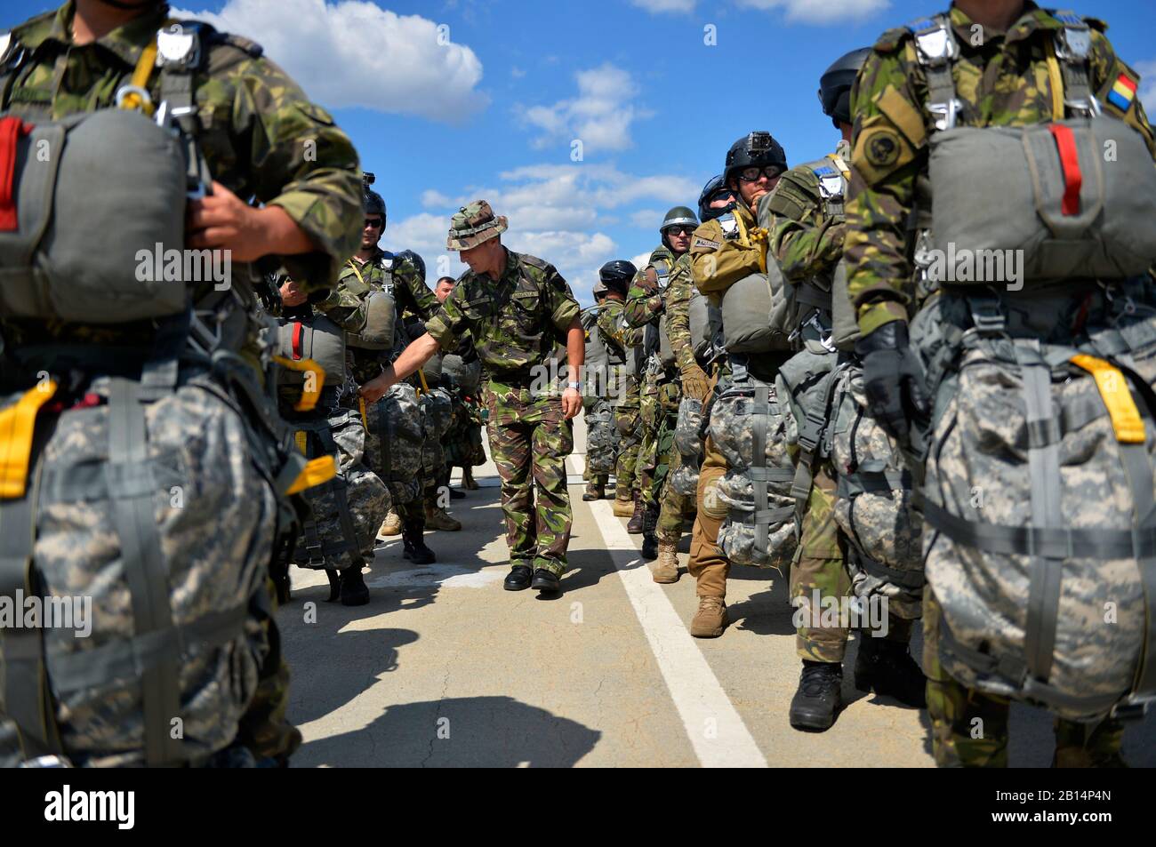 A Romanian military member inspects his troops as they prepare to board a U.S. Air Force C-130J Super Hercules during a bilateral training exercise with U.S. forces at Boboc Air Base, Romania, Aug. 24, 2017. U.S. and Romanian troops joined forces for Carpathian Fall, which aims to promote interoperability and unit cohesion among allies. (U.S. Air Force photo by Airman 1st Class Joshua Magbanua) Stock Photo