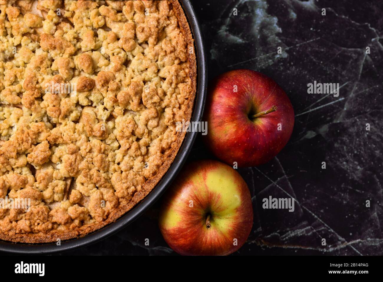 European apple pie with topping crumbles in springform pan on right